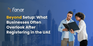 Business professionals reviewing documents against a Dubai skyline with the headline “Beyond Setup: What Businesses Often Overlook After Registering in the UAE,” representing post-registration compliance, advisory, and corporate management considerations.